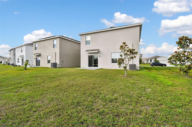 16126 Sunday Stroll Way, Odessa, FL 33556 - back of house with stucco siding, cooling unit, and a yard
