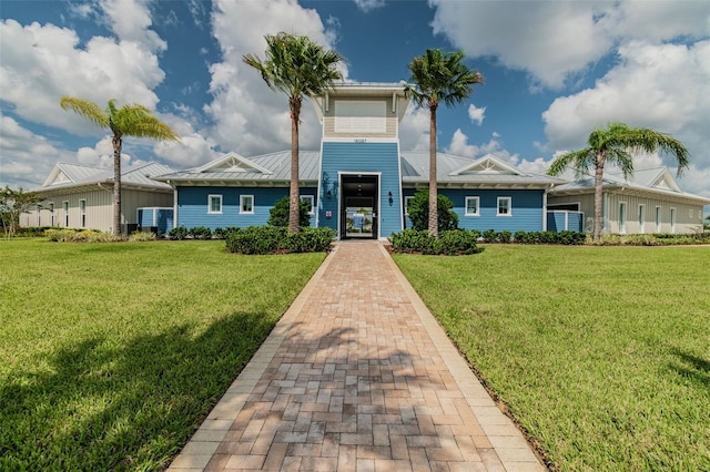 16126 Sunday Stroll Way, Odessa, FL 33556 - view of front facade with a standing seam roof, metal roof, and a front yard
