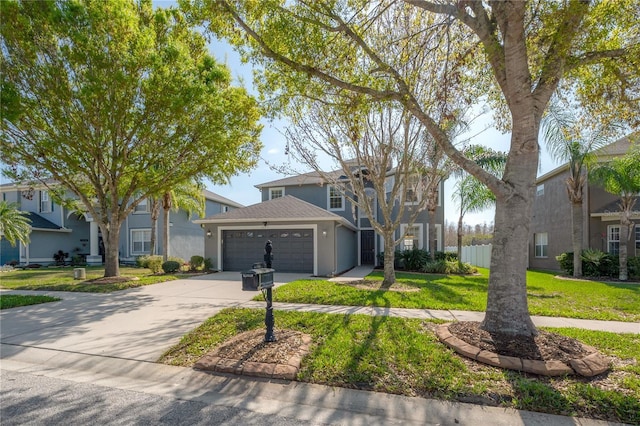 view of front facade featuring a front yard, fence, an attached garage, stucco siding, and concrete driveway