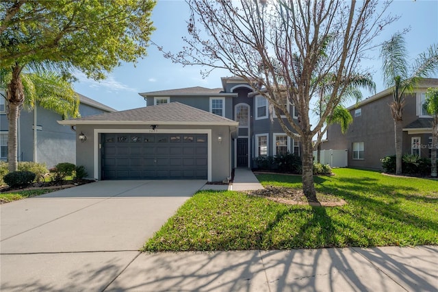 view of front of home with stucco siding, driveway, a front yard, and a garage