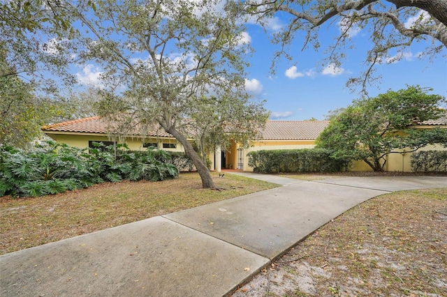 mediterranean / spanish house featuring a front yard