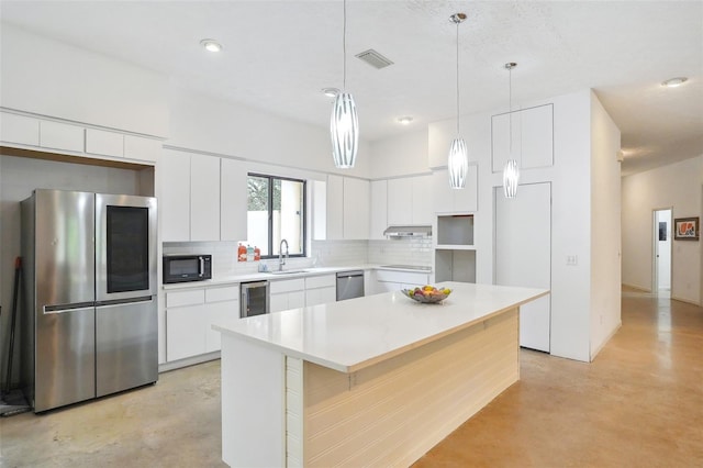 kitchen with white cabinetry, sink, beverage cooler, a center island, and stainless steel appliances