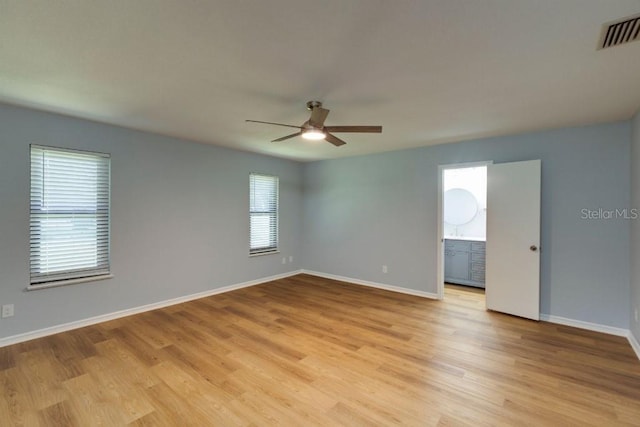 unfurnished room featuring ceiling fan and light wood-type flooring