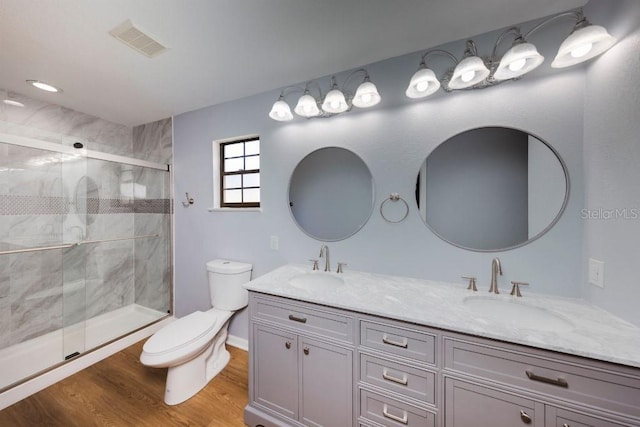 bathroom with vanity, wood-type flooring, toilet, and walk in shower