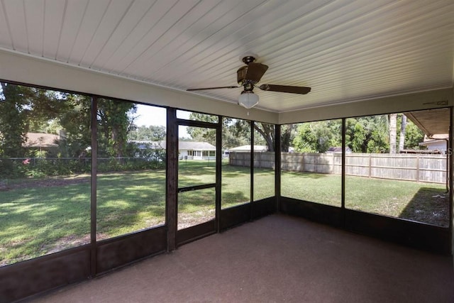 unfurnished sunroom featuring ceiling fan