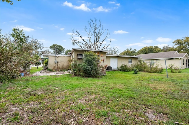 rear view of property with a yard