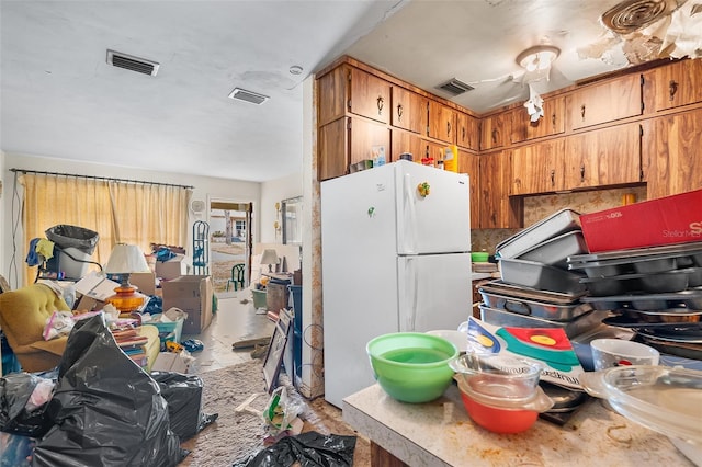 kitchen featuring white fridge and decorative backsplash