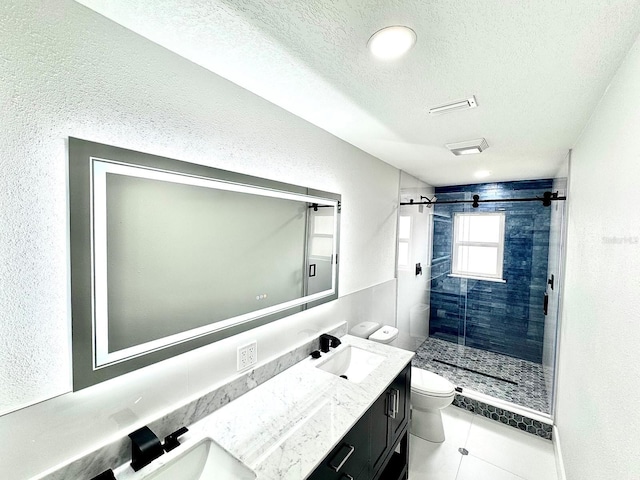 full bath featuring a sink, a textured ceiling, toilet, and double vanity