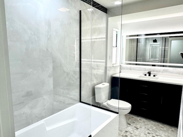 bathroom with bathing tub / shower combination, vanity, toilet, and tile walls