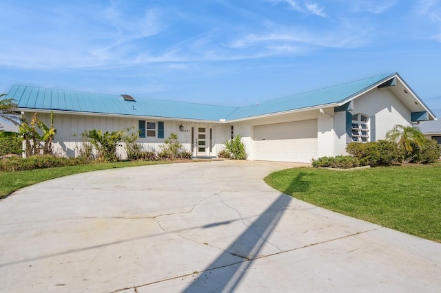 single story home featuring a garage and a front lawn