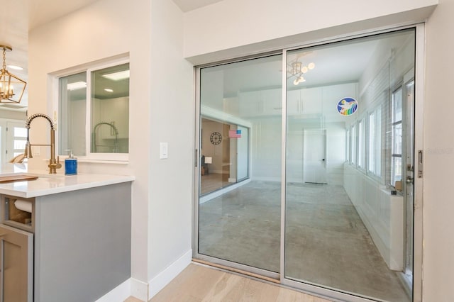 bathroom with a notable chandelier, hardwood / wood-style floors, and a wealth of natural light