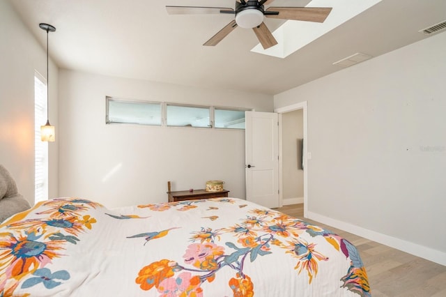 bedroom with ceiling fan and light hardwood / wood-style floors