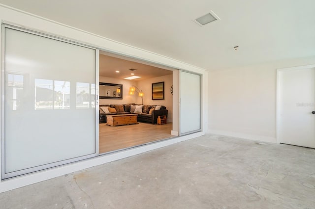 unfurnished room featuring concrete flooring