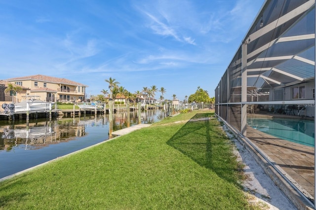 view of yard featuring a lanai and a water view