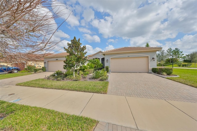 view of front of property with a garage and a front lawn