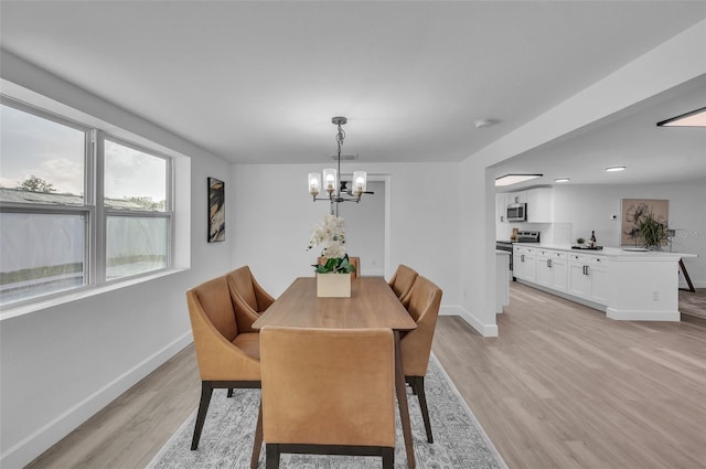 dining room featuring a chandelier and light hardwood / wood-style floors