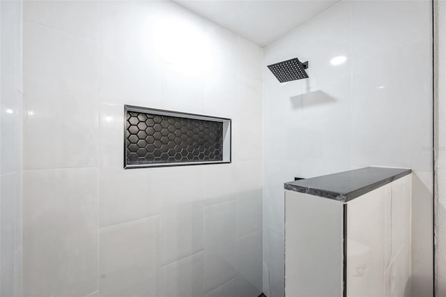 bathroom with a tile shower