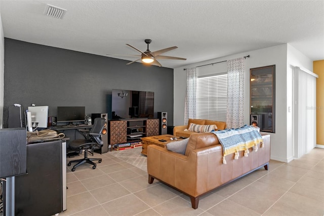 living room featuring a textured ceiling, light tile patterned flooring, and ceiling fan