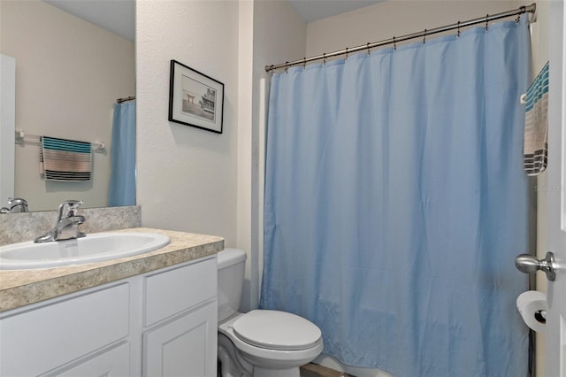 bathroom featuring toilet and vanity