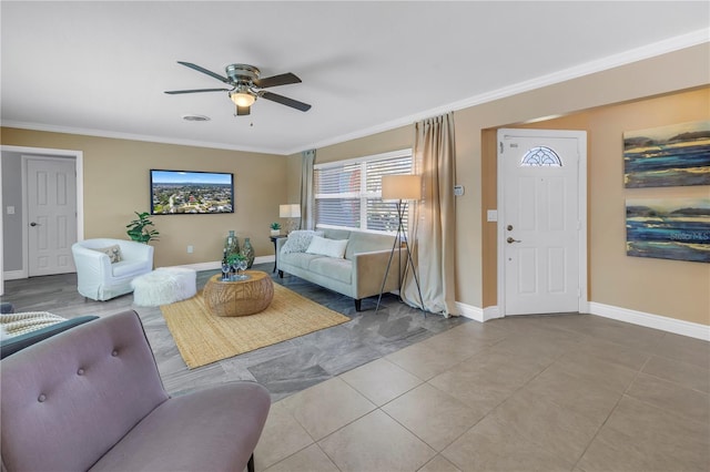 living room featuring ceiling fan, ornamental molding, light tile patterned floors, and baseboards