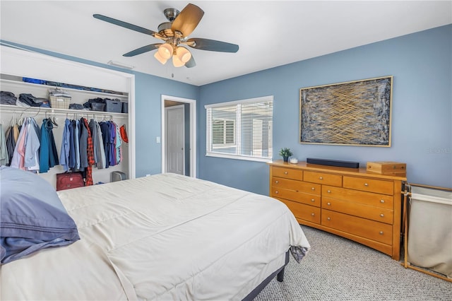 bedroom featuring light carpet, a closet, and a ceiling fan