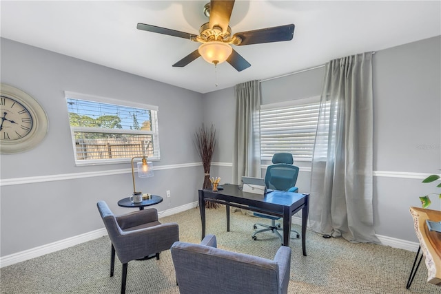 office featuring carpet, baseboards, ceiling fan, and a wealth of natural light