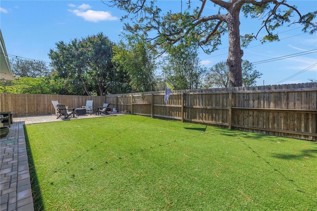 view of yard with a patio area and a fenced backyard