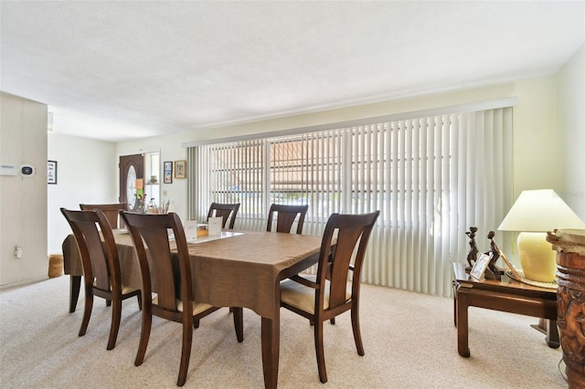 dining room with light carpet