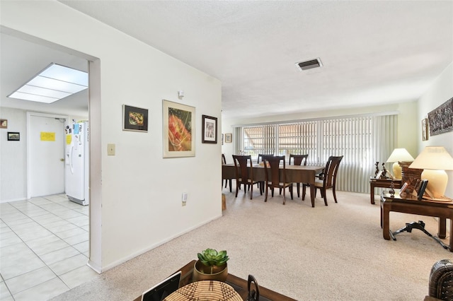 dining space with light colored carpet