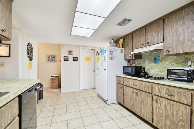 kitchen with light tile patterned floors, decorative backsplash, and black appliances