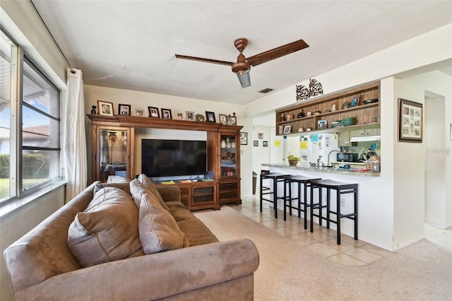 living room with light tile patterned flooring and ceiling fan