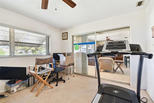 home office with light carpet and ceiling fan