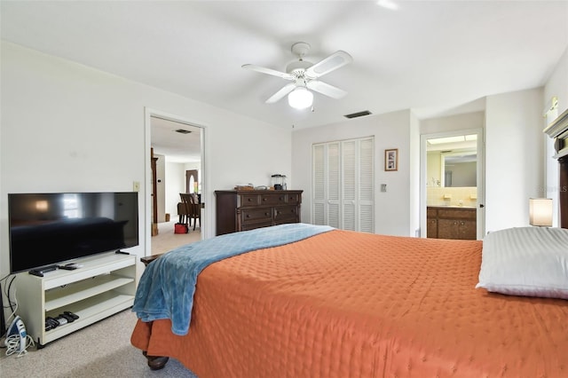 carpeted bedroom featuring connected bathroom, a closet, and ceiling fan