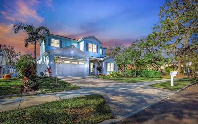 view of front of house with a garage and a yard