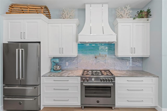 kitchen featuring white cabinetry, backsplash, custom exhaust hood, and high quality appliances