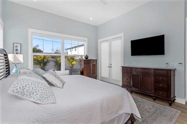 bedroom with light hardwood / wood-style flooring, a closet, and ceiling fan