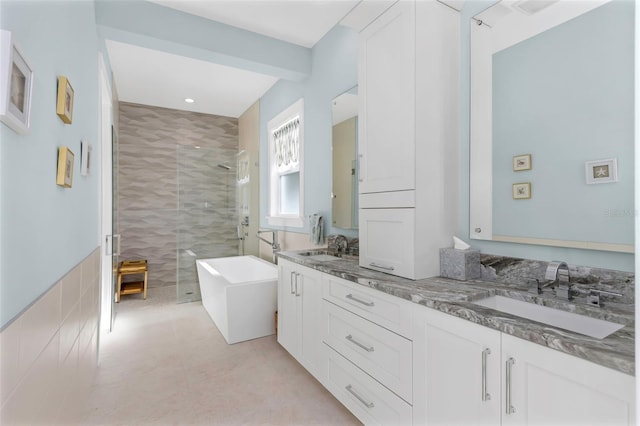 bathroom with tile patterned floors, vanity, and shower with separate bathtub