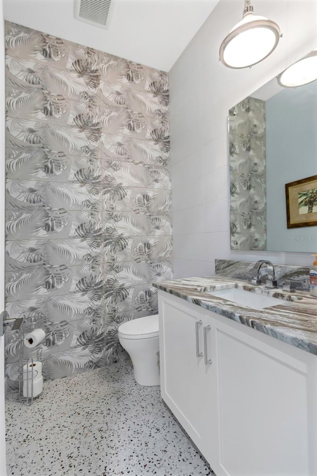 bathroom with vanity and toilet