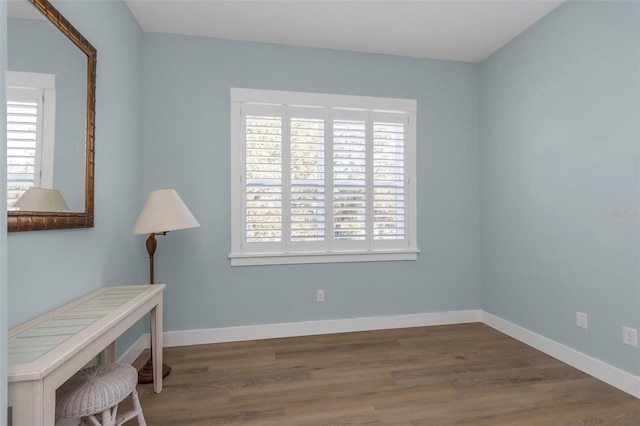 sitting room with dark wood-type flooring