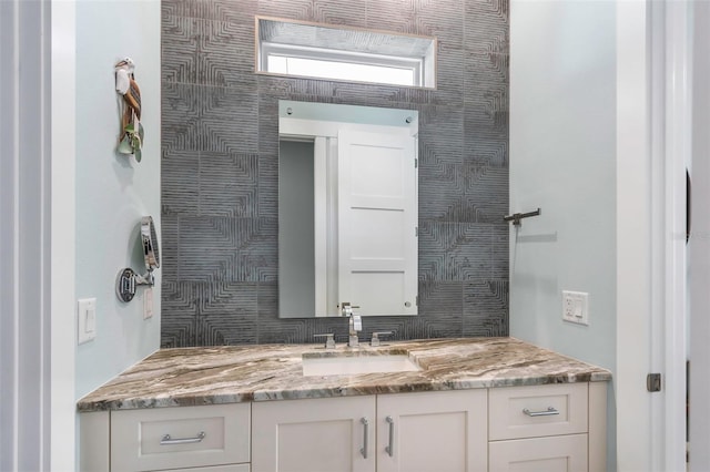 bathroom featuring tasteful backsplash and vanity