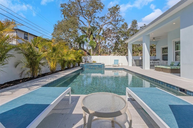 view of swimming pool featuring ceiling fan, a jacuzzi, an outdoor bar, and a patio area