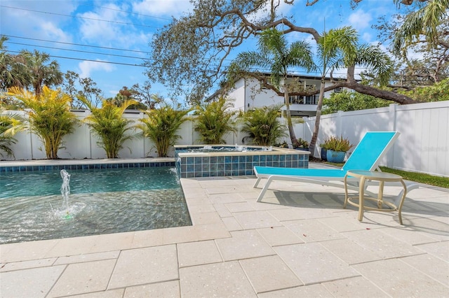 view of swimming pool featuring pool water feature, an in ground hot tub, and a patio area