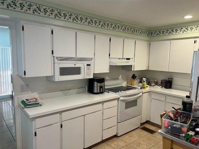 kitchen featuring white cabinetry, light tile patterned floors, and white appliances