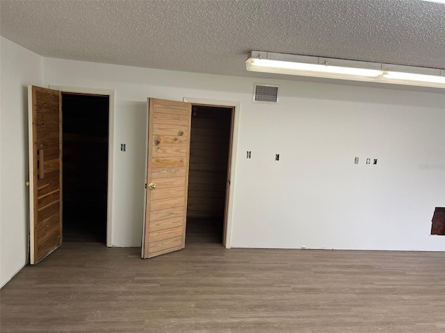 empty room featuring hardwood / wood-style floors and a textured ceiling