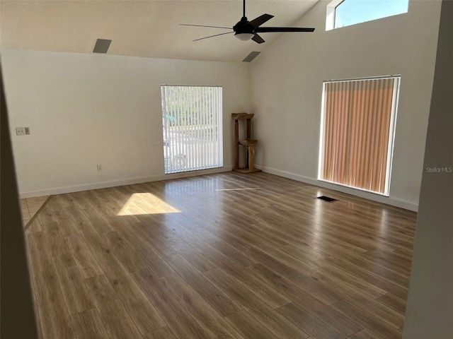 spare room with high vaulted ceiling, dark hardwood / wood-style floors, and ceiling fan