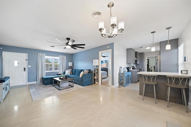 living room with ceiling fan with notable chandelier