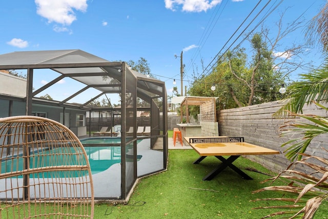 view of pool with a lawn, a lanai, and a fenced in pool