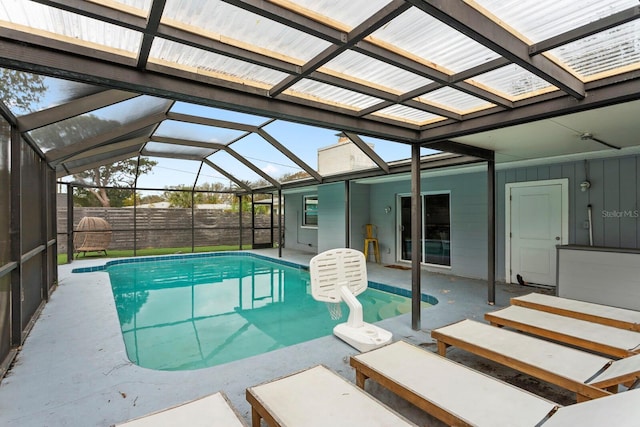 view of swimming pool featuring a lanai, a patio area, fence, and a fenced in pool