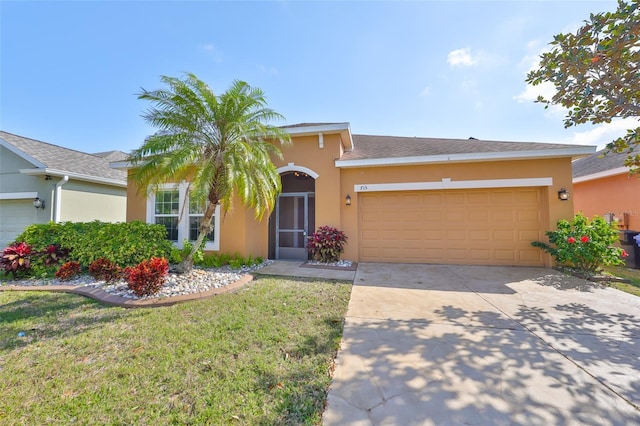 view of front of home featuring a garage and a front yard