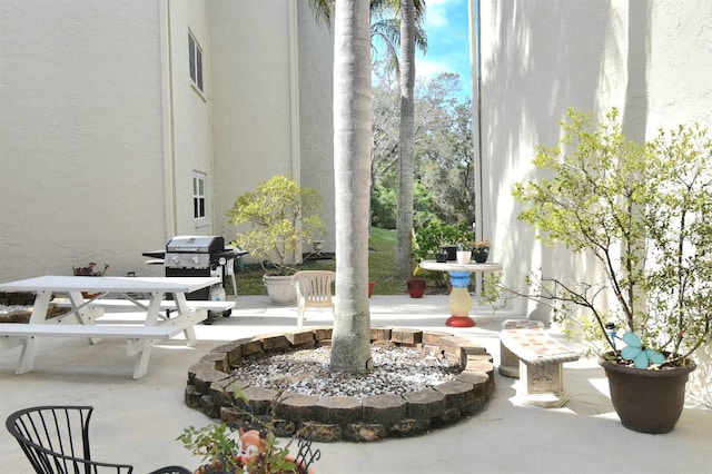 view of patio with outdoor dining space and a grill